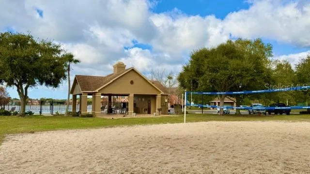 a view of a house with a big yard and potted plants