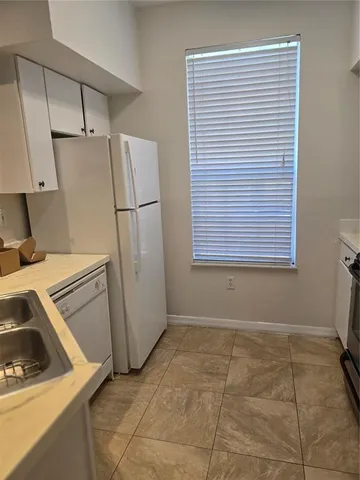 a kitchen with a refrigerator and window
