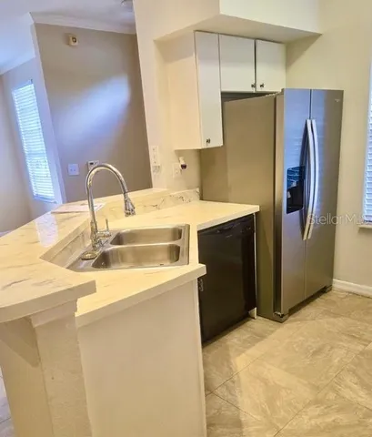 a kitchen with stainless steel appliances a refrigerator and a stove