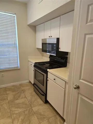 a kitchen with a stove and a microwave