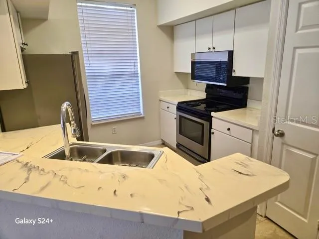 a kitchen with a sink and a stove