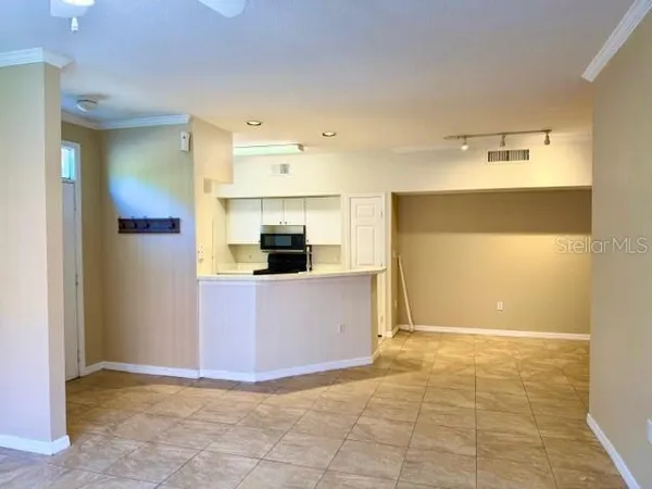 a view of kitchen with stainless steel appliances a refrigerator and a stove