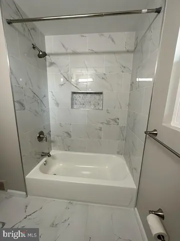 a white bath tub and a shower