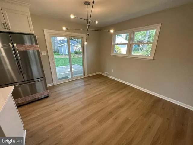 a view of a kitchen with a sink and dishwasher wooden floor