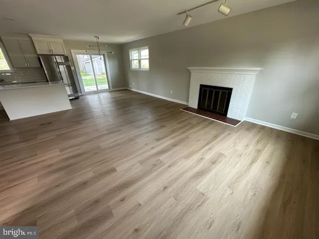 an empty room with wooden floor and a window