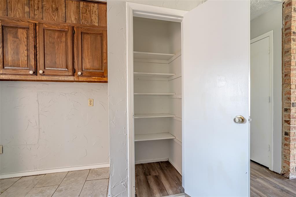 601 Henry Street Dublin, TX 76446 - Photo 13 of 40 a view of walk in closet with empty racks