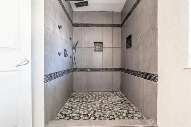a bathroom with a toilet and a shower