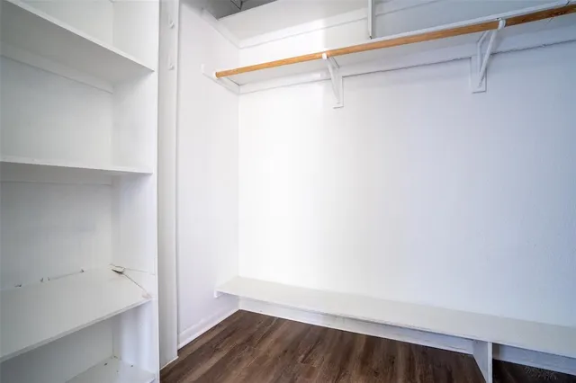 a view of small space with wooden floor and a ceiling fan