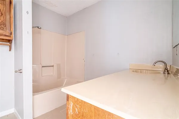 a view of room with a ceiling fan and window