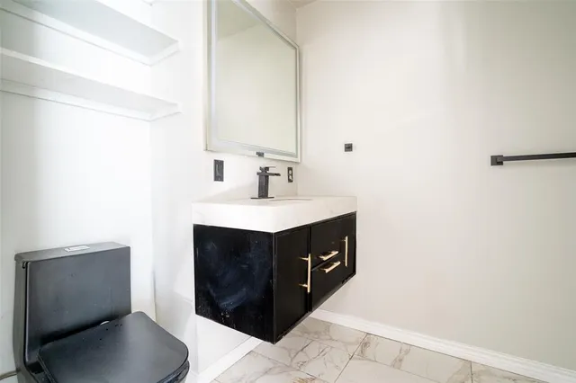 a bathroom with a sink a toilet and a mirror