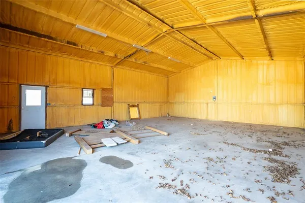 a view of garage with a table and chairs under an umbrella