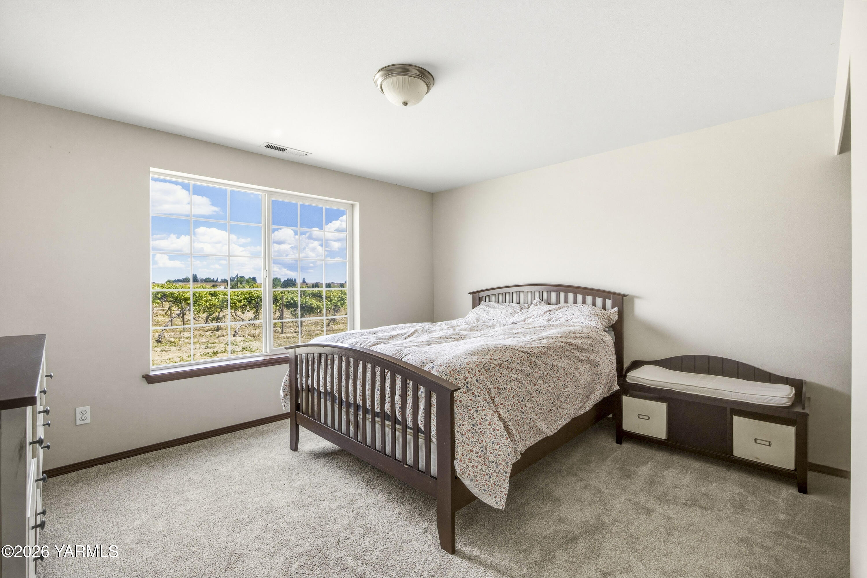 2050 Olmstead Road Grandview, WA 98930 - Photo 22 of 60 a spacious bedroom with a bed and a window