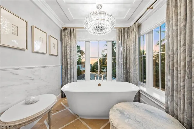 a spacious bathroom with a granite countertop sink mirror and bathtub