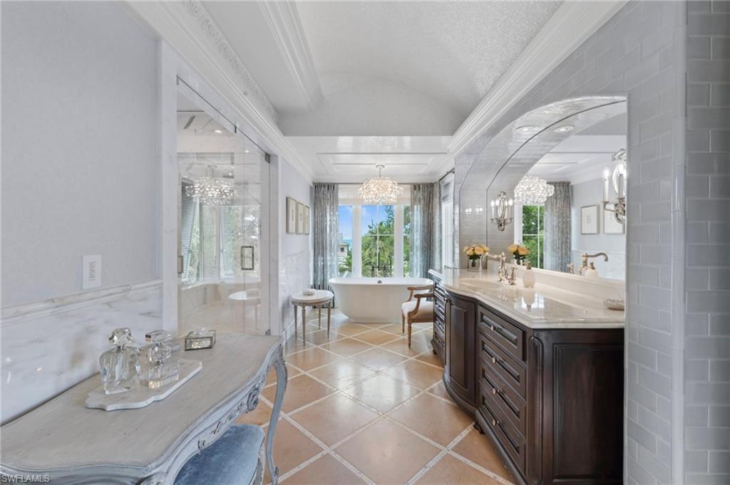 3675 Gordon Drive Naples, FL 34102 - Photo 14 of 50 a spacious bathroom with a granite countertop sink mirror and bathtub