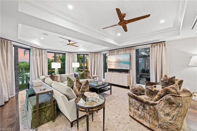 a living room with fireplace furniture and a chandelier