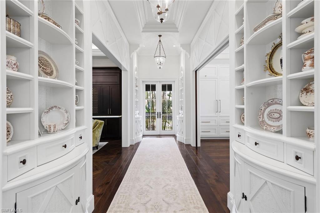3675 Gordon Drive Naples, FL 34102 - Photo 20 of 50 a hallway with cabinets and window