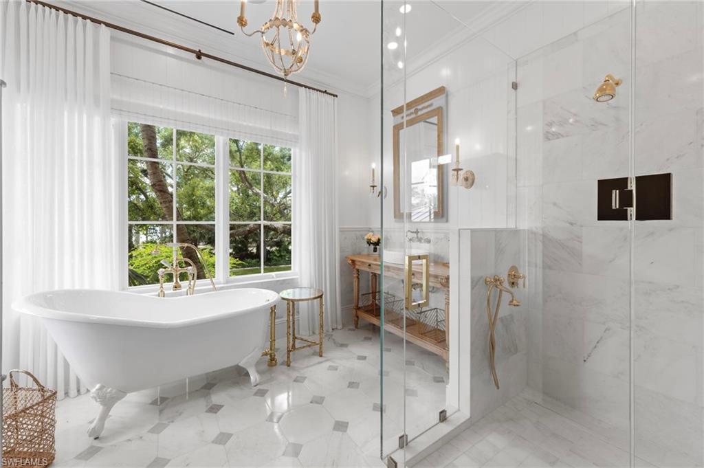 3675 Gordon Drive Naples, FL 34102 - Photo 24 of 50 a bathroom with a bathtub sink and toilet