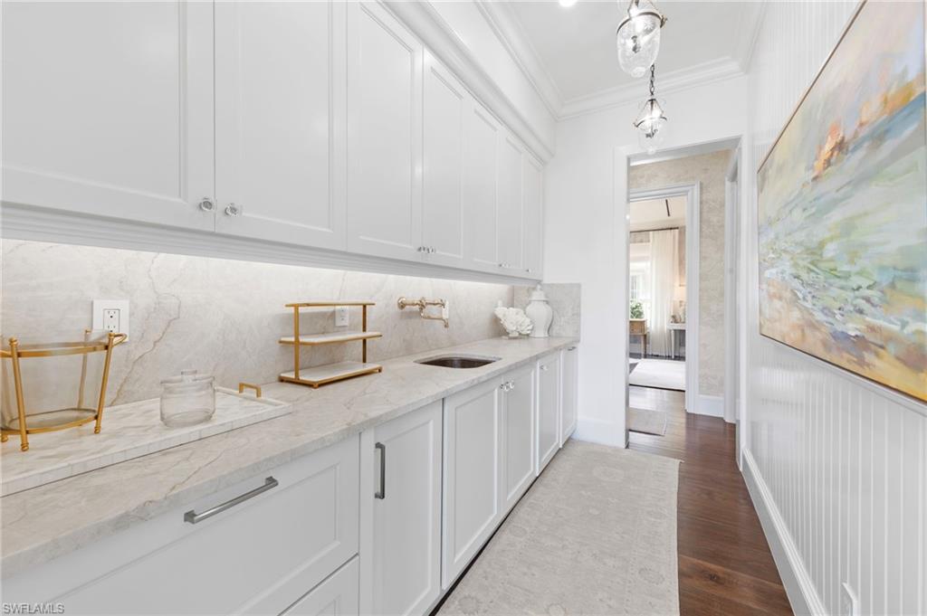 3675 Gordon Drive Naples, FL 34102 - Photo 31 of 50 a bathroom with a sink a mirror and a bathtub