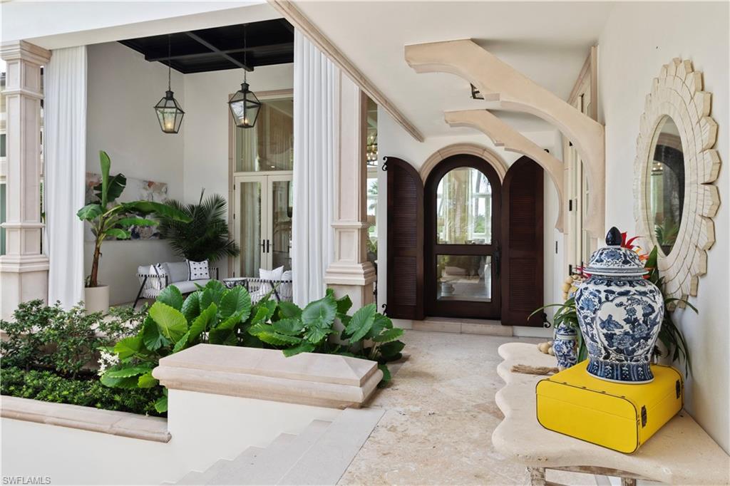 3675 Gordon Drive Naples, FL 34102 - Photo 33 of 50 a view of front door with outdoor seating