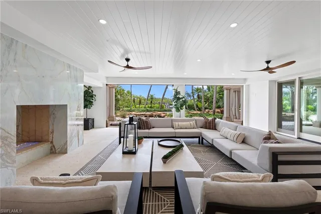 a white bench sitting in front of a house