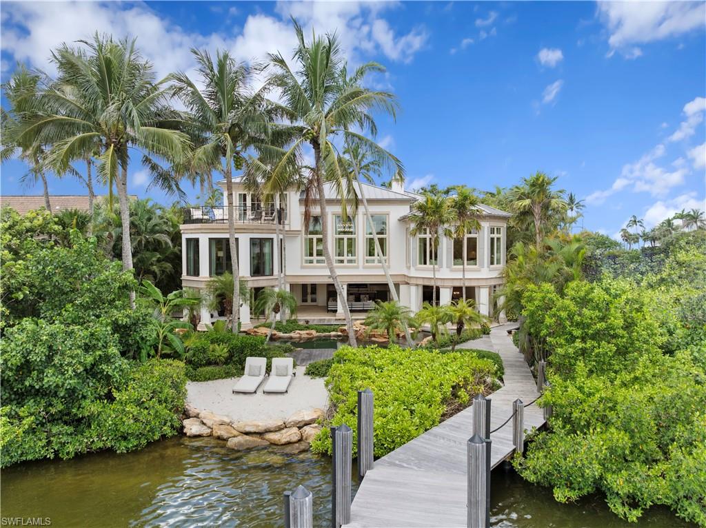 3675 Gordon Drive Naples, FL 34102 - Photo 38 of 50 a house with swimming pool in front of it