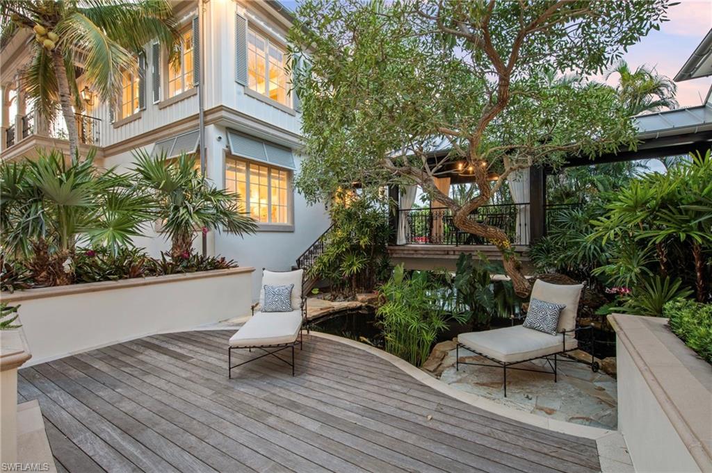3675 Gordon Drive Naples, FL 34102 - Photo 39 of 50 a white bench sitting in front of a house