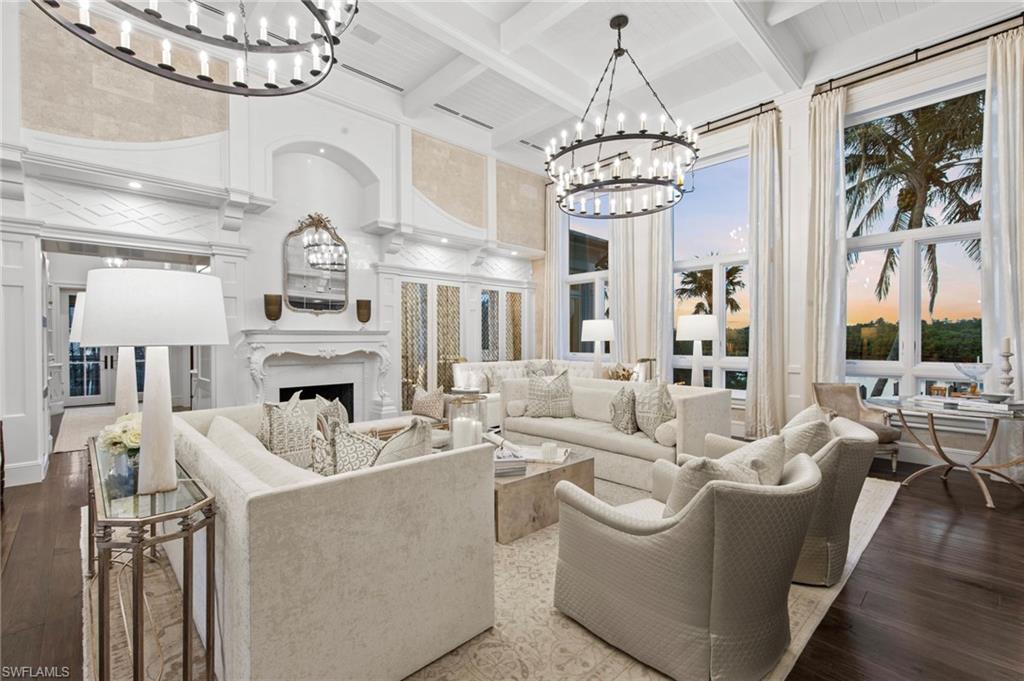 3675 Gordon Drive Naples, FL 34102 - Photo 5 of 50 a living room with furniture a chandelier and a fireplace