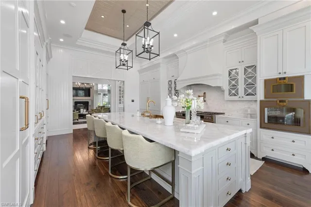 a kitchen with a white cabinets and chandelier