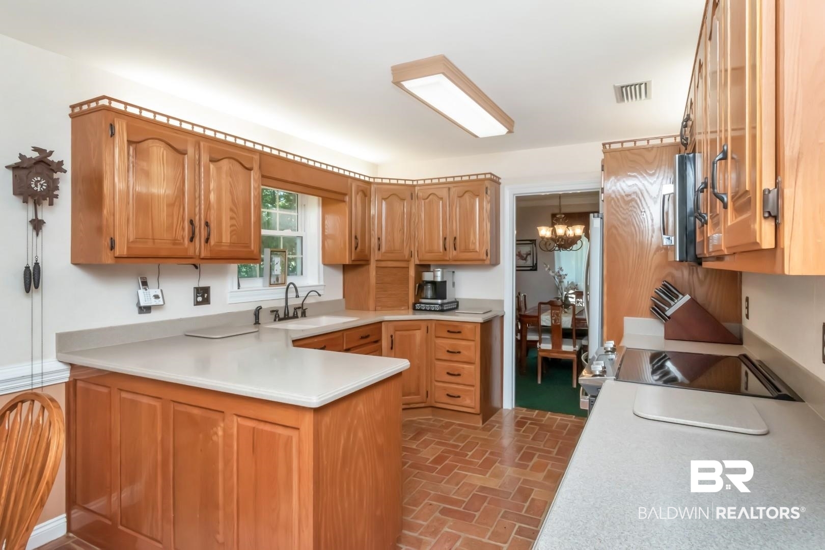 8220 Fordham Road Mobile, AL 36619 - Photo 5 of 41 Kitchen featuring a notable chandelier, visible vents, a sink, a peninsula, and light countertops