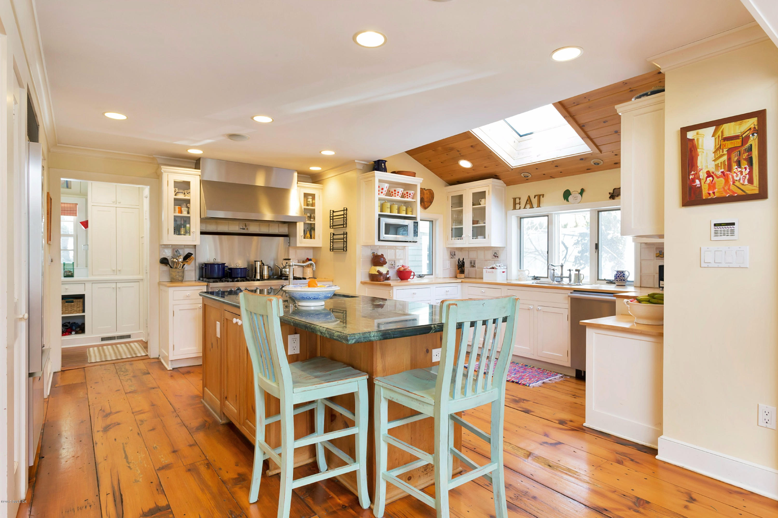 49 Gilliam Lane Riverside, CT 06878 - Photo 11 of 38 a dining room with stainless steel appliances kitchen island granite countertop a dining table chairs and view living room