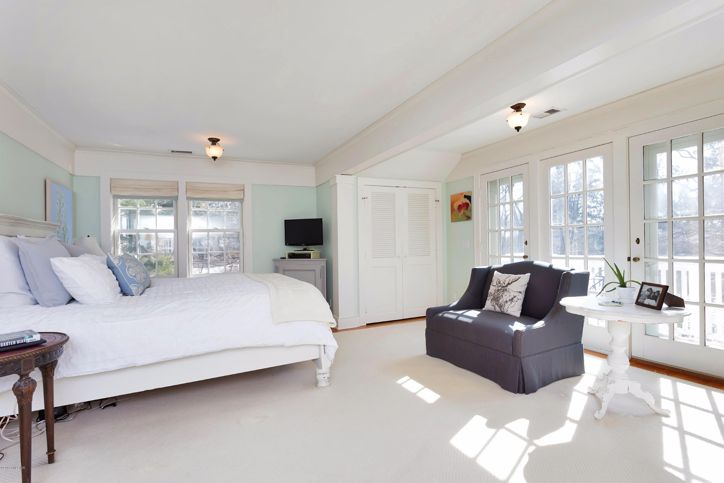 49 Gilliam Lane Riverside, CT 06878 - Photo 27 of 38 a bedroom with a bed couch and large window