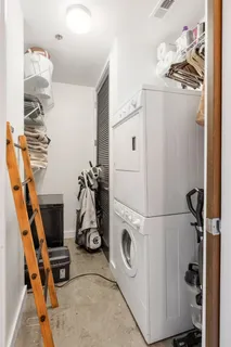 a storage room with cabinets and refrigerator