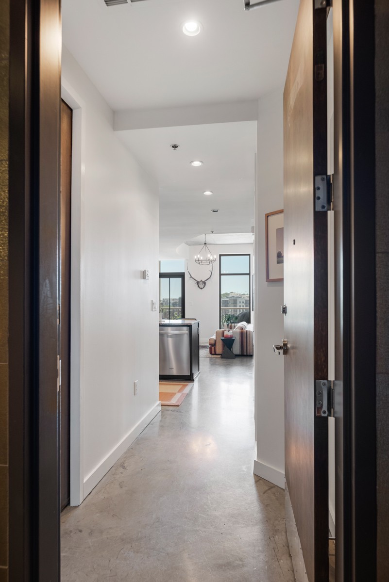 1510 Demonbreun Street, Unit 701 Nashville, TN 37203 - Photo 2 of 22 a view of a hallway with a livingroom and furniture