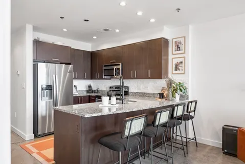 a kitchen with kitchen island appliances cabinets and furniture