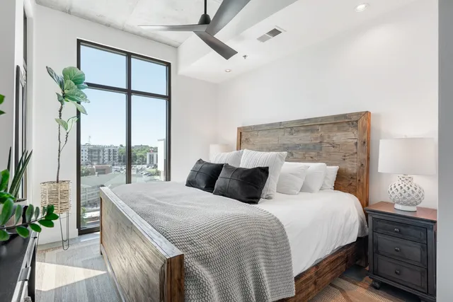 a bedroom with a large bed and a window