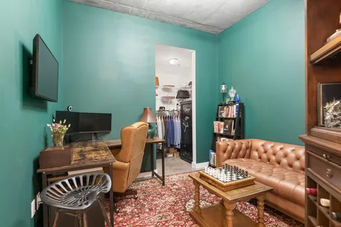 a living room with furniture a rug and a lamp