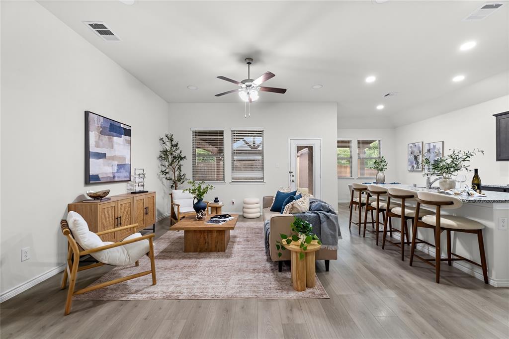 2908 Frio Road Little Elm, TX 75068 - Photo 3 of 26 Spacious open-concept living area featuring wood-finish flooring and recessed lighting throughout