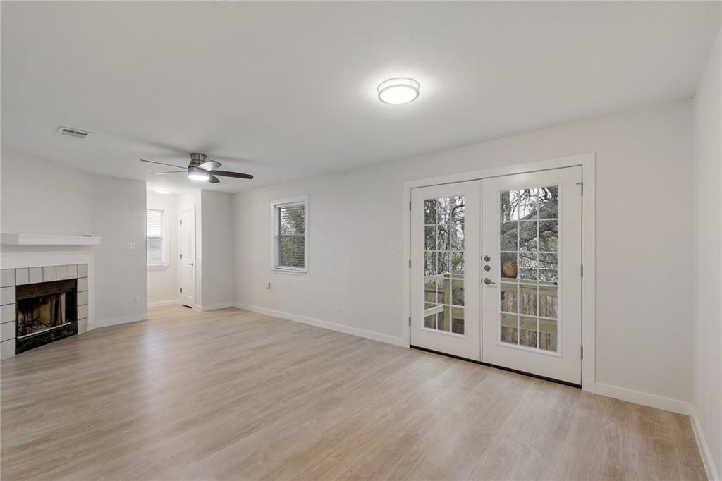 15209 Sun-Bird Lane, Unit A Austin, TX 78734 - Photo 1 of 1 a view of an empty room with a fireplace and a window