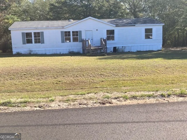 a view of a house with a swimming pool and a yard