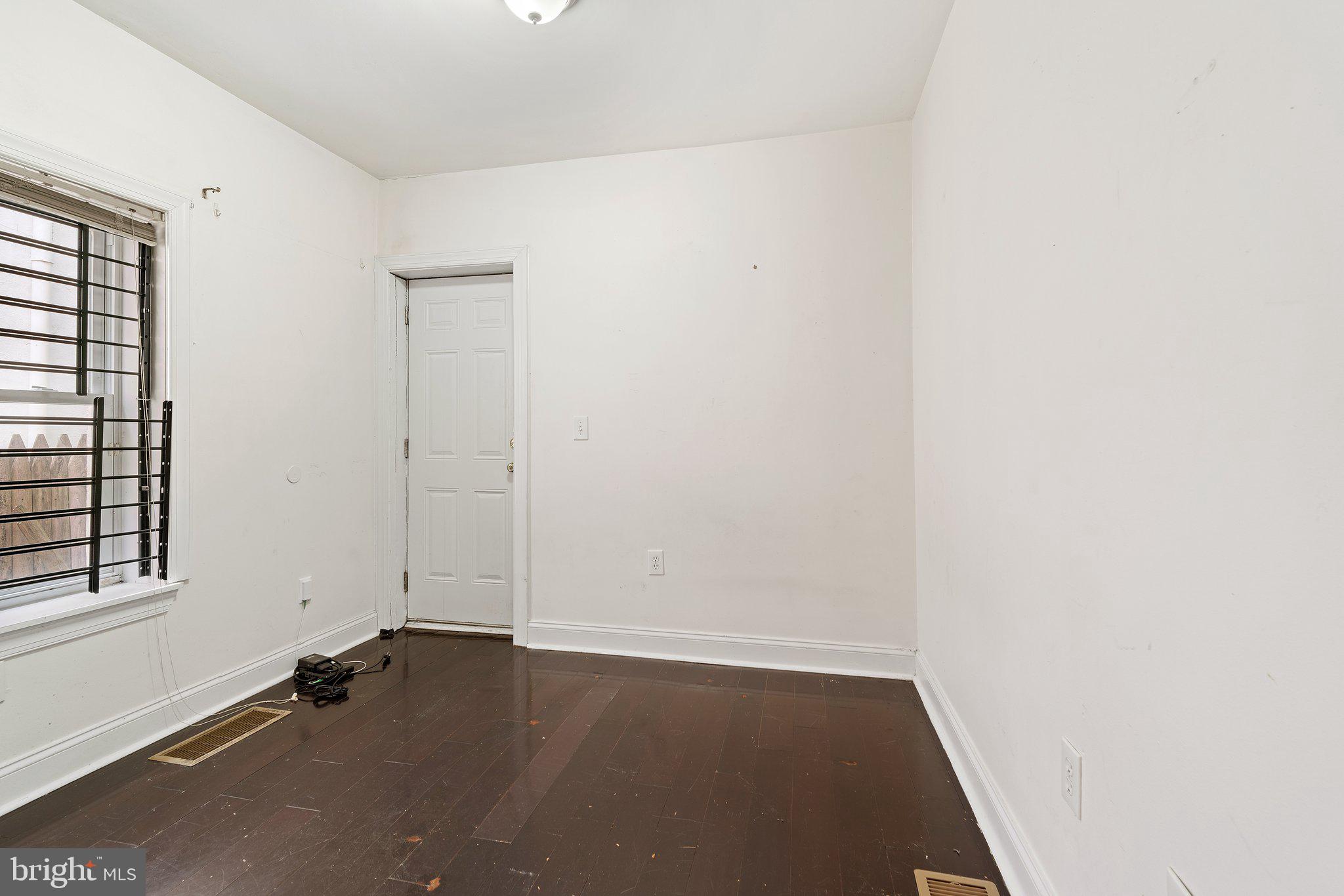 1729 Fontain Street, Unit 1 Philadelphia, PA 19121 - Photo 12 of 25 an empty room with wooden floor and windows