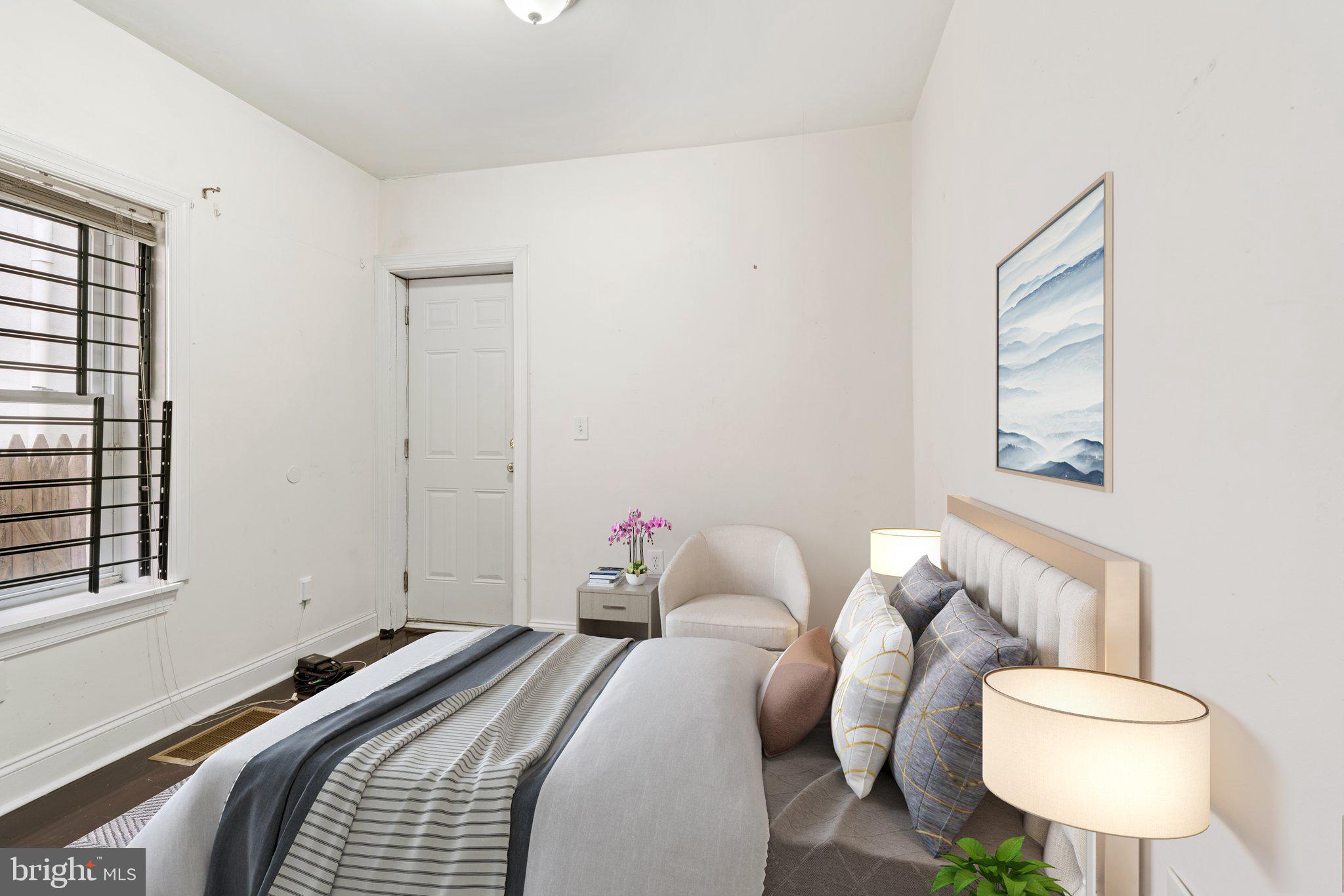 1729 Fontain Street, Unit 1 Philadelphia, PA 19121 - Photo 13 of 25 a bedroom with a bed and wooden floor