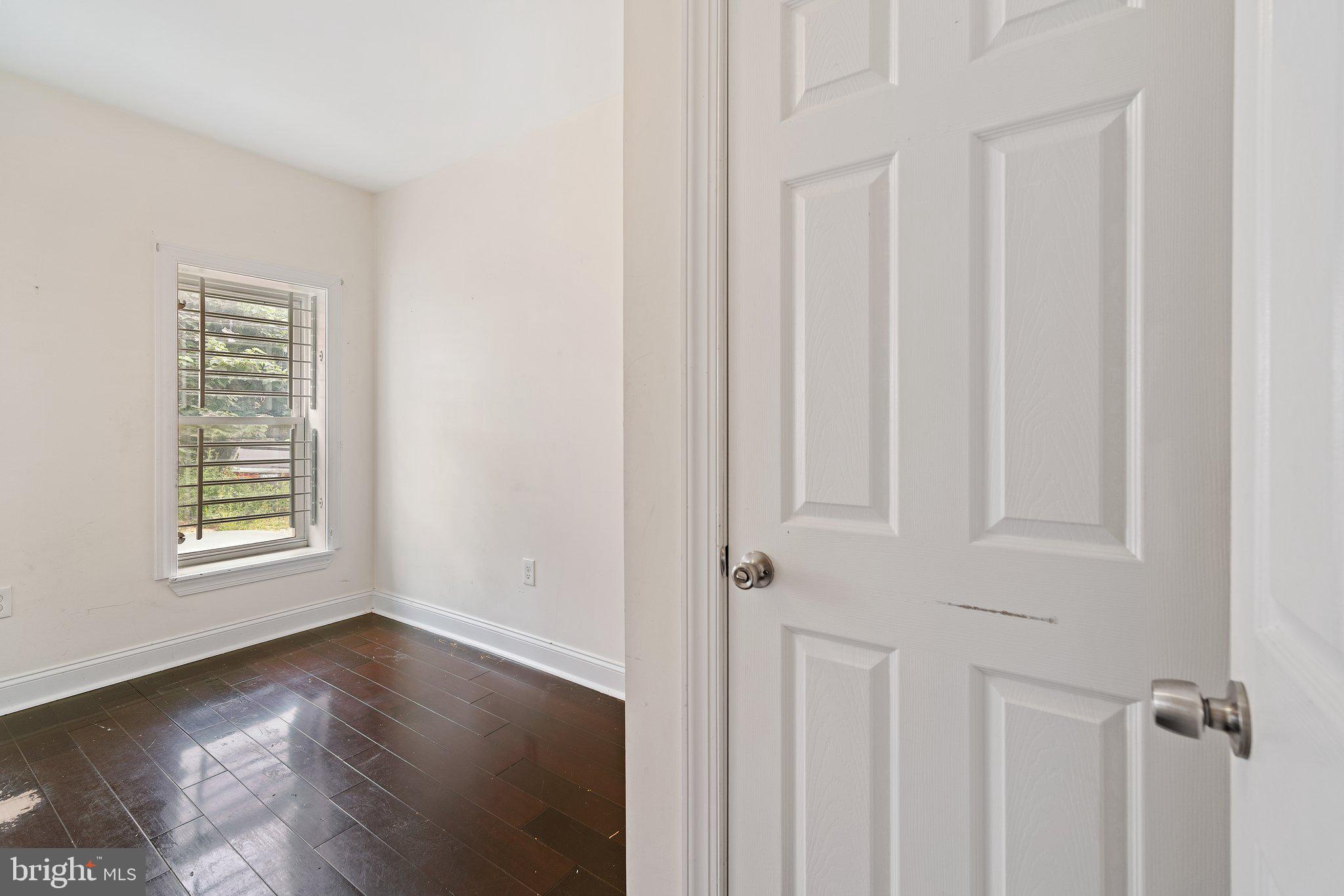 1729 Fontain Street, Unit 1 Philadelphia, PA 19121 - Photo 16 of 25 an empty room with wooden floor and windows