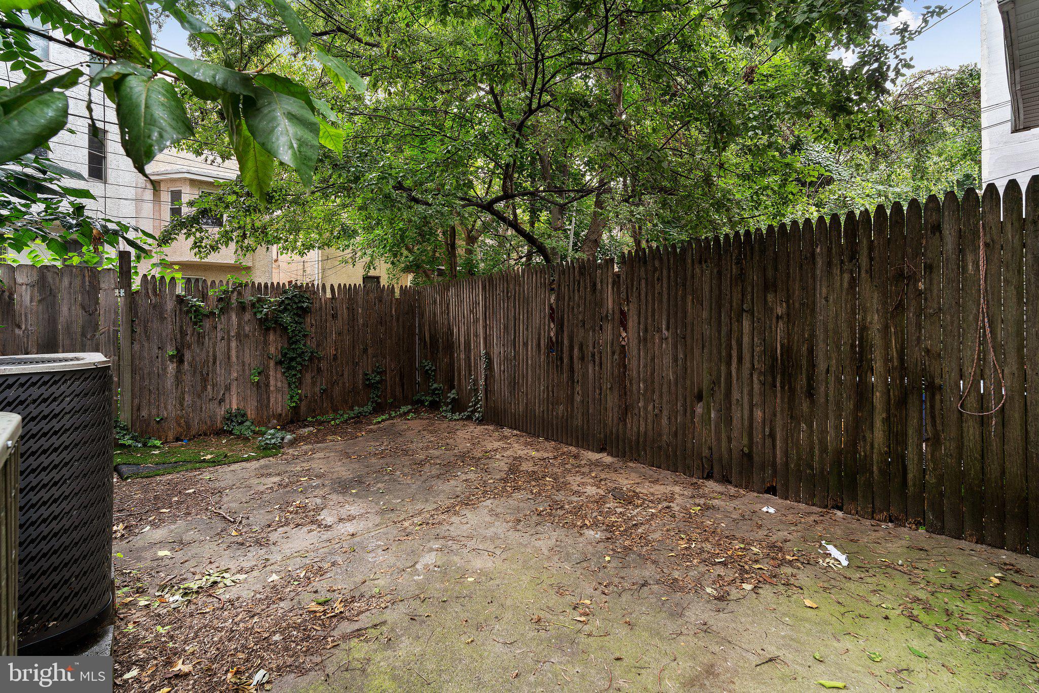 1729 Fontain Street, Unit 1 Philadelphia, PA 19121 - Photo 22 of 25 a backyard of a house with lawn chairs and wooden fence