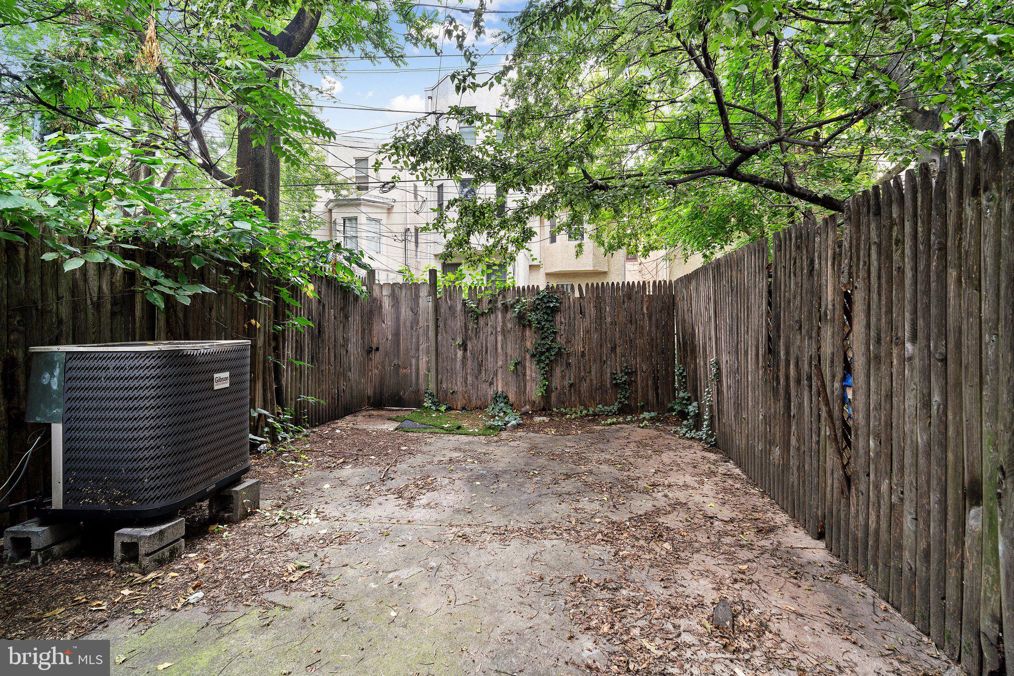 1729 Fontain Street, Unit 1 Philadelphia, PA 19121 - Photo 23 of 25 a wooden fence with trees in the background