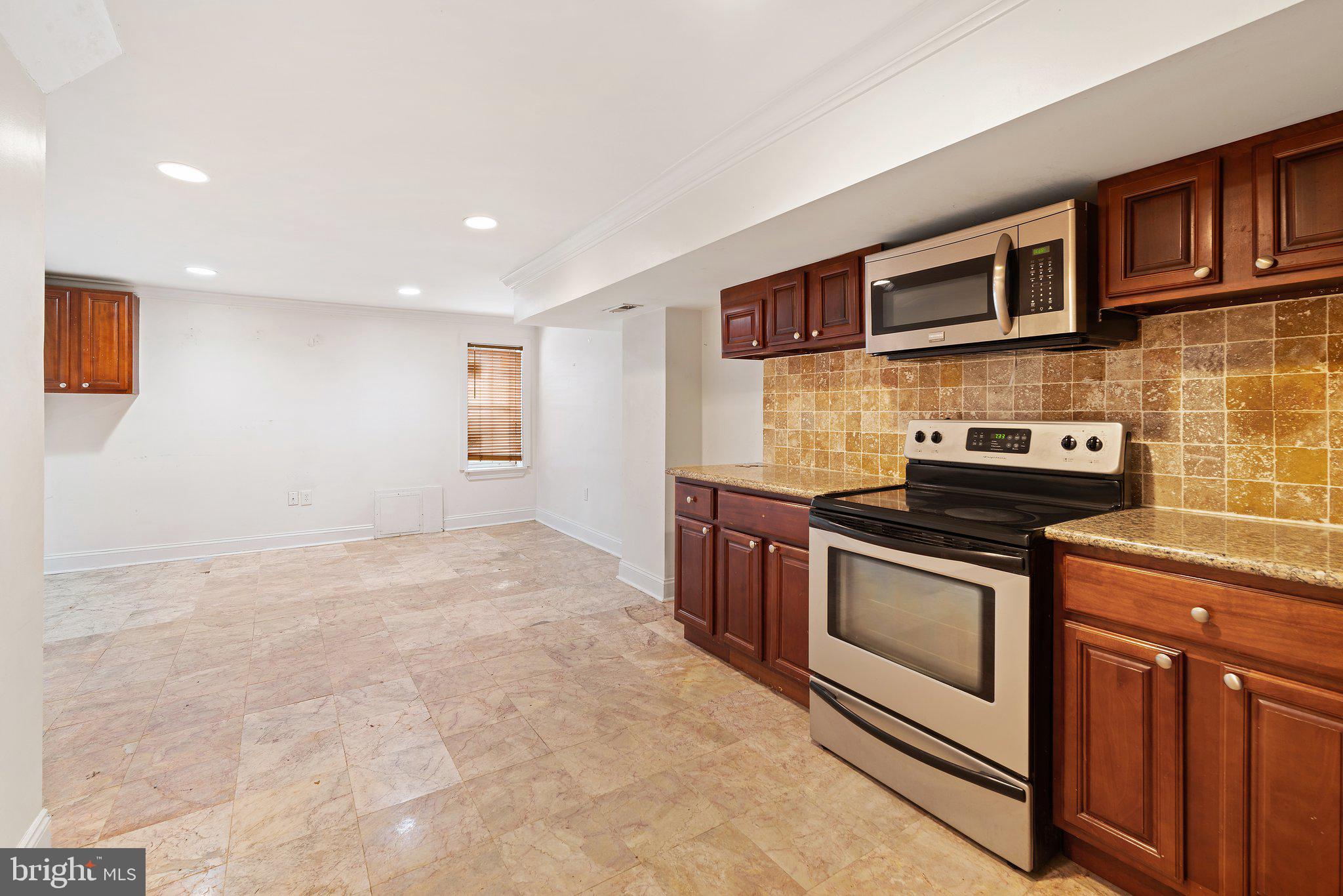 1729 Fontain Street, Unit 1 Philadelphia, PA 19121 - Photo 3 of 25 a kitchen with stainless steel appliances granite countertop a stove and a sink