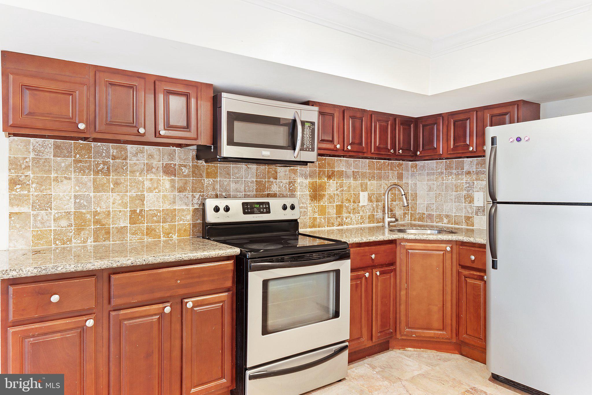 1729 Fontain Street, Unit 1 Philadelphia, PA 19121 - Photo 5 of 25 a kitchen with stainless steel appliances granite countertop a refrigerator stove a sink and dishwasher
