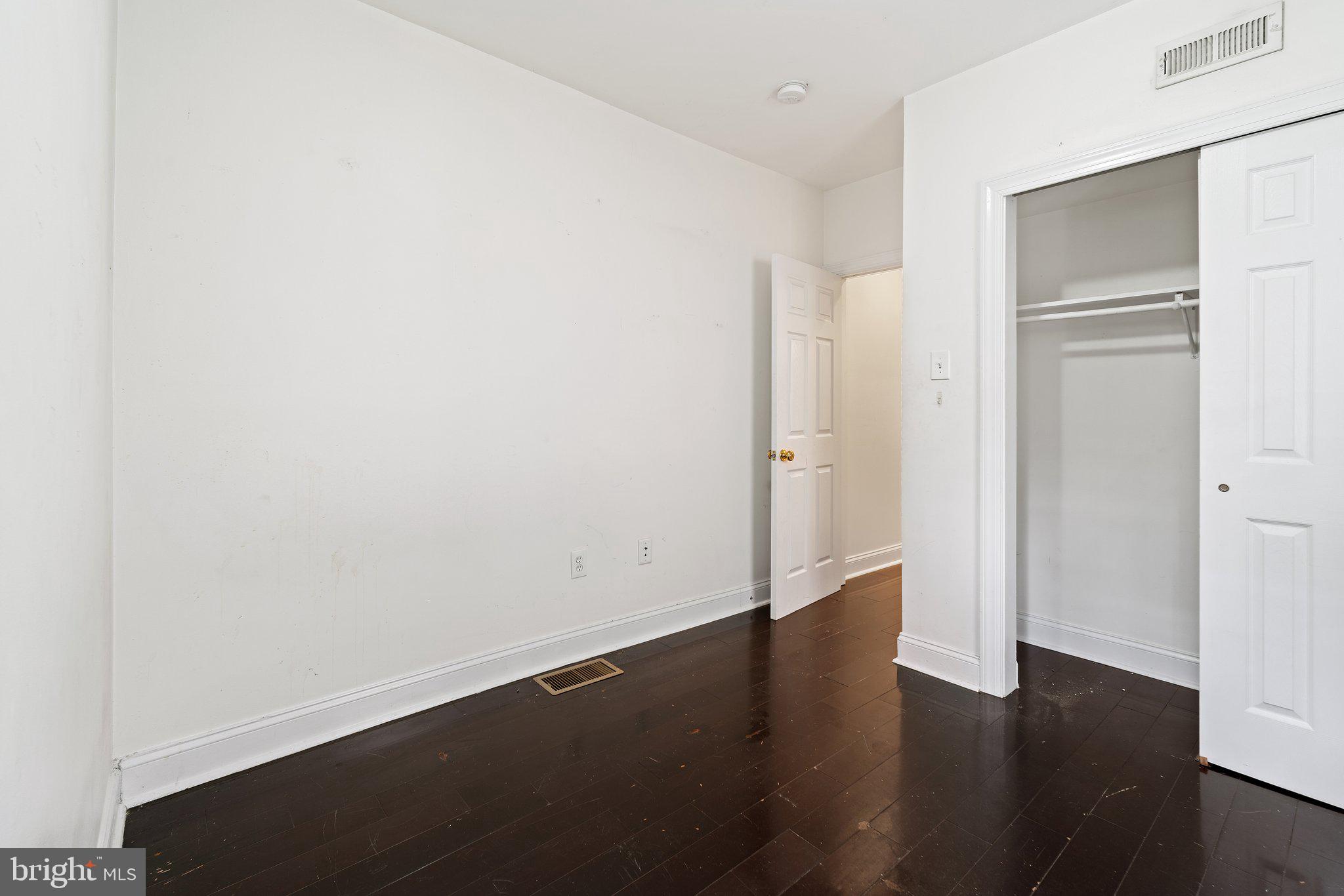 1729 Fontain Street, Unit 1 Philadelphia, PA 19121 - Photo 9 of 25 an empty room with wooden floor and closet