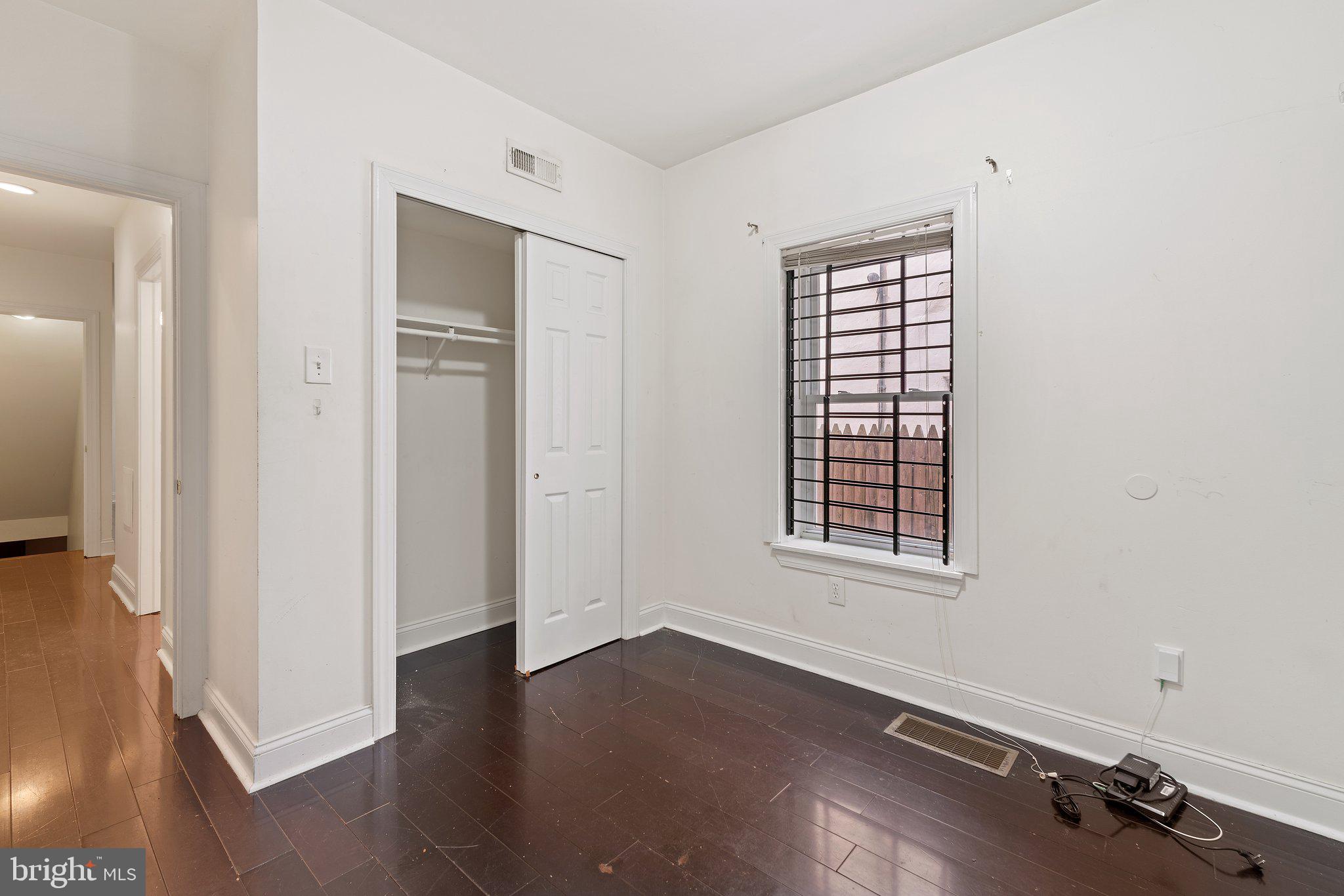 1729 Fontain Street, Unit 1 Philadelphia, PA 19121 - Photo 10 of 25 an empty room with wooden floor and windows