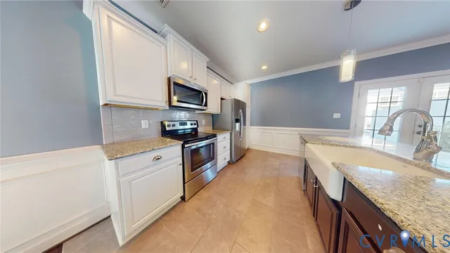 a kitchen with granite countertop a sink stove and refrigerator