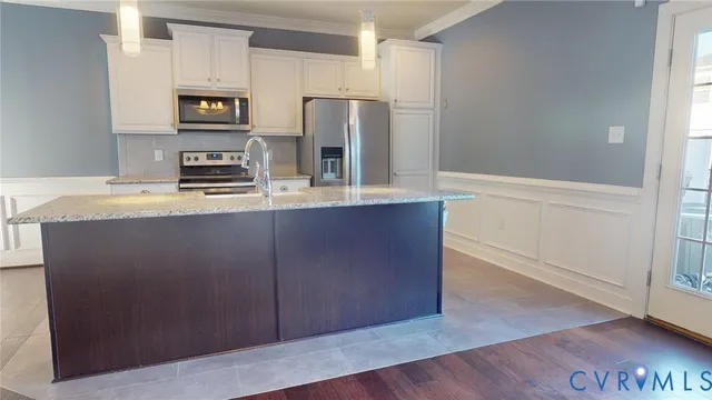 a kitchen with stainless steel appliances a refrigerator and a stove
